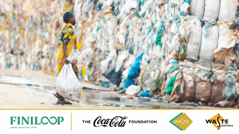 Women dressed in yellow carrying waste to a pile of waste